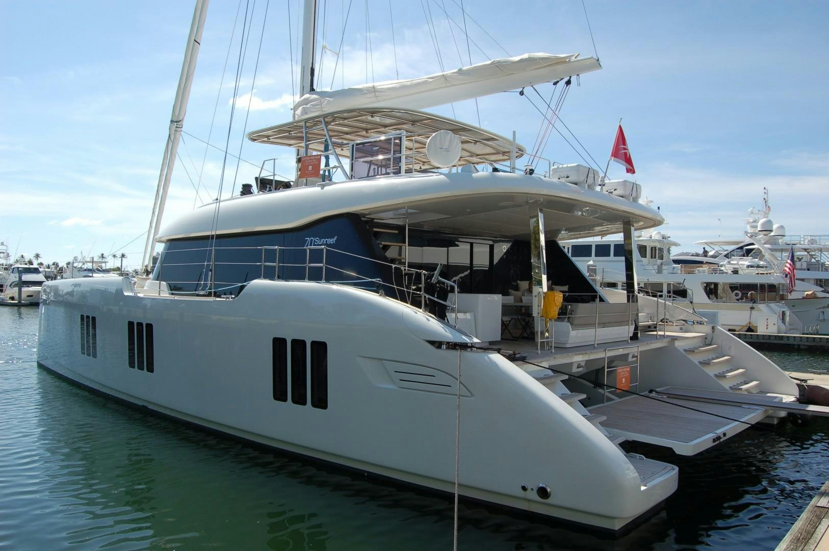 a large white boat in a harbor aboard OCEAN VIBES Yacht for Sale