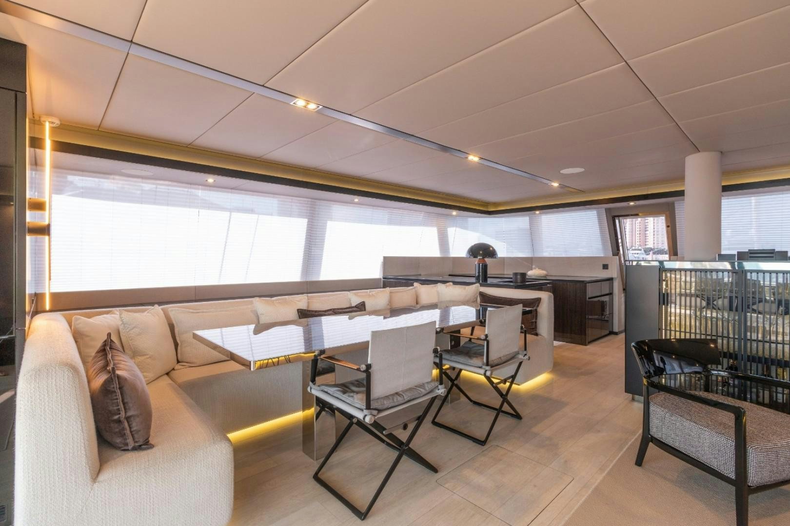a room with a couch and a table and chairs aboard OCEAN VIBES Yacht for Sale