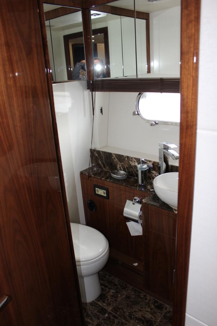 a bathroom with a toilet and a sink aboard GEMINI Yacht for Sale