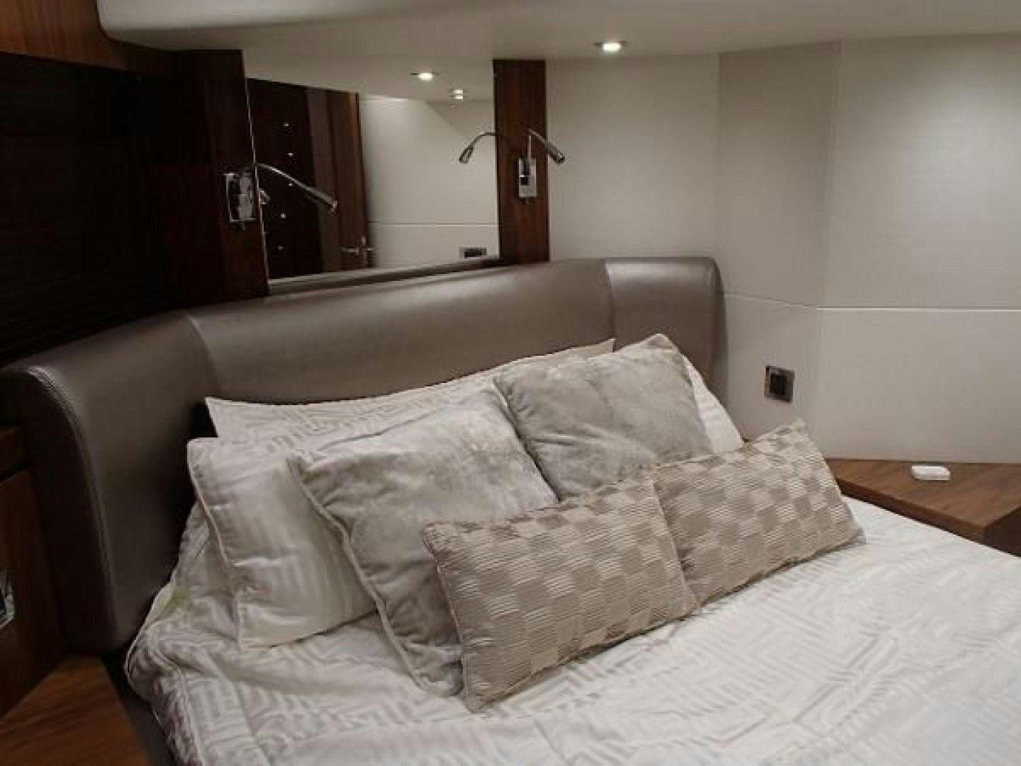 a bed with white pillows aboard GEMINI Yacht for Sale