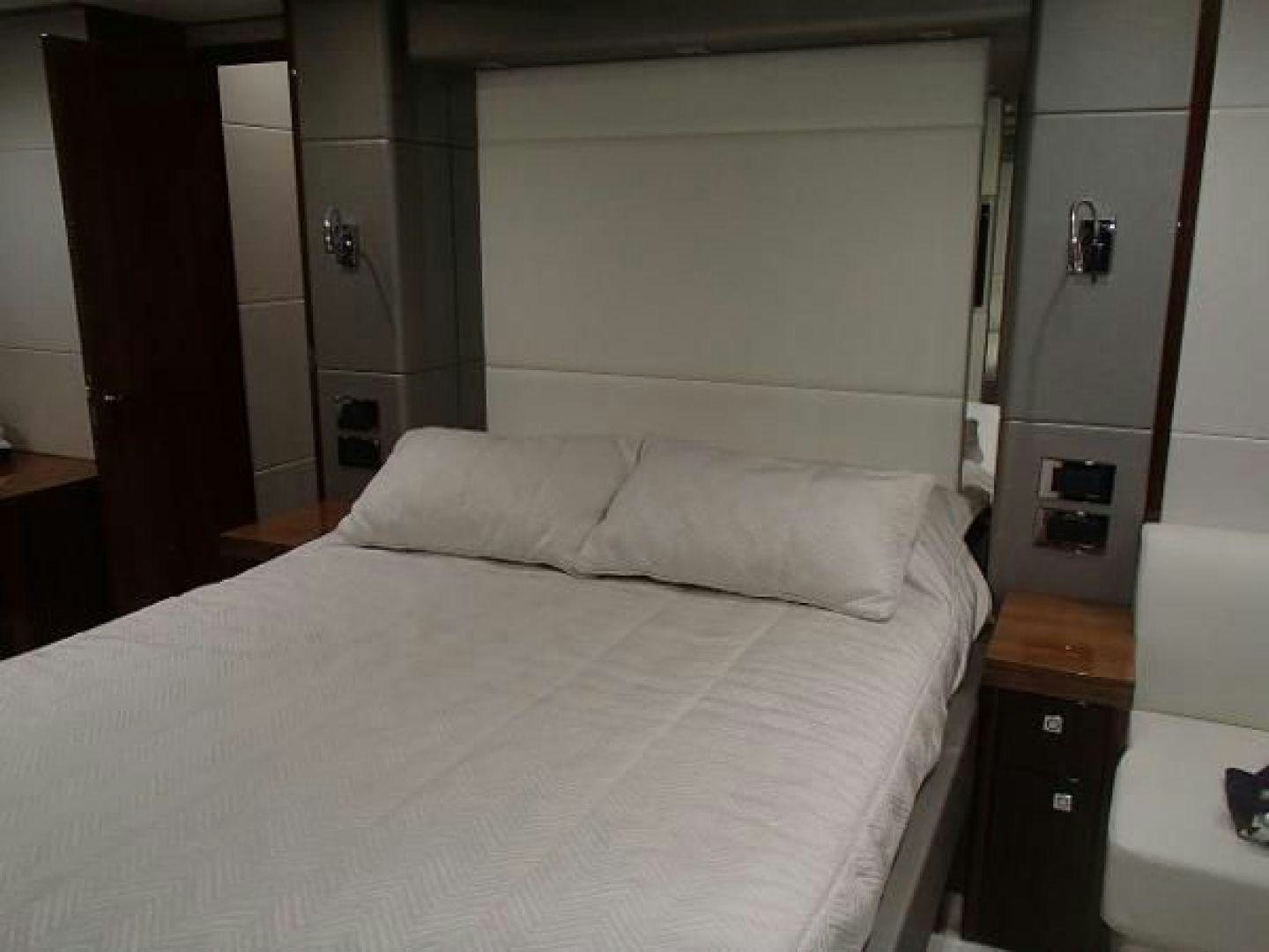 a bed with a white sheet aboard GEMINI Yacht for Sale