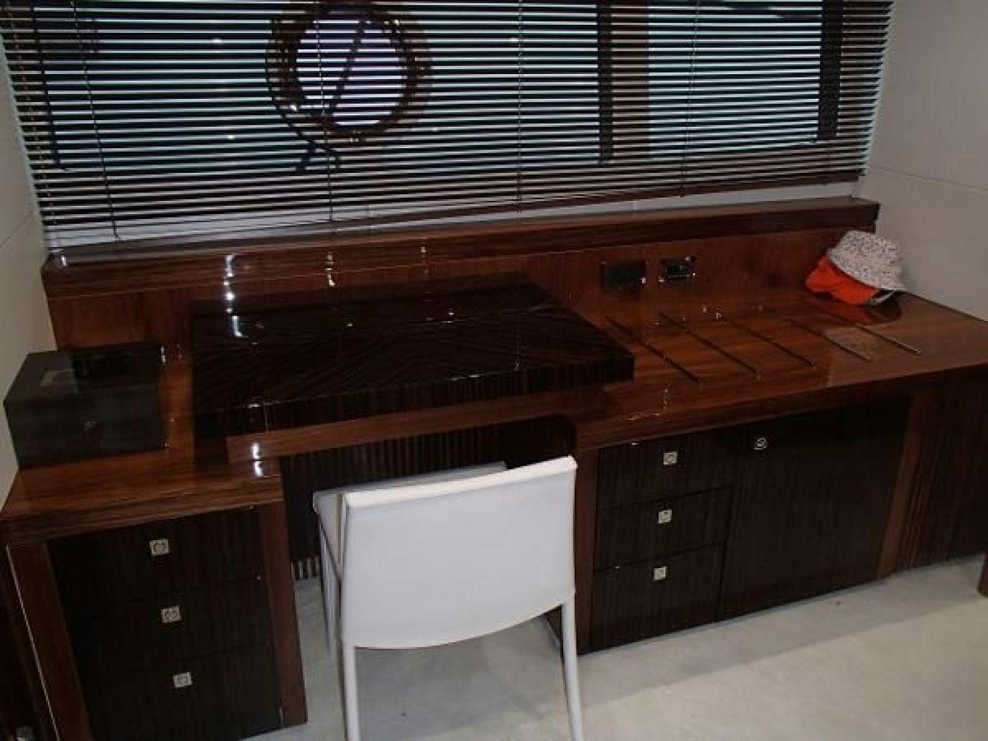 a white chair next to a piano aboard GEMINI Yacht for Sale