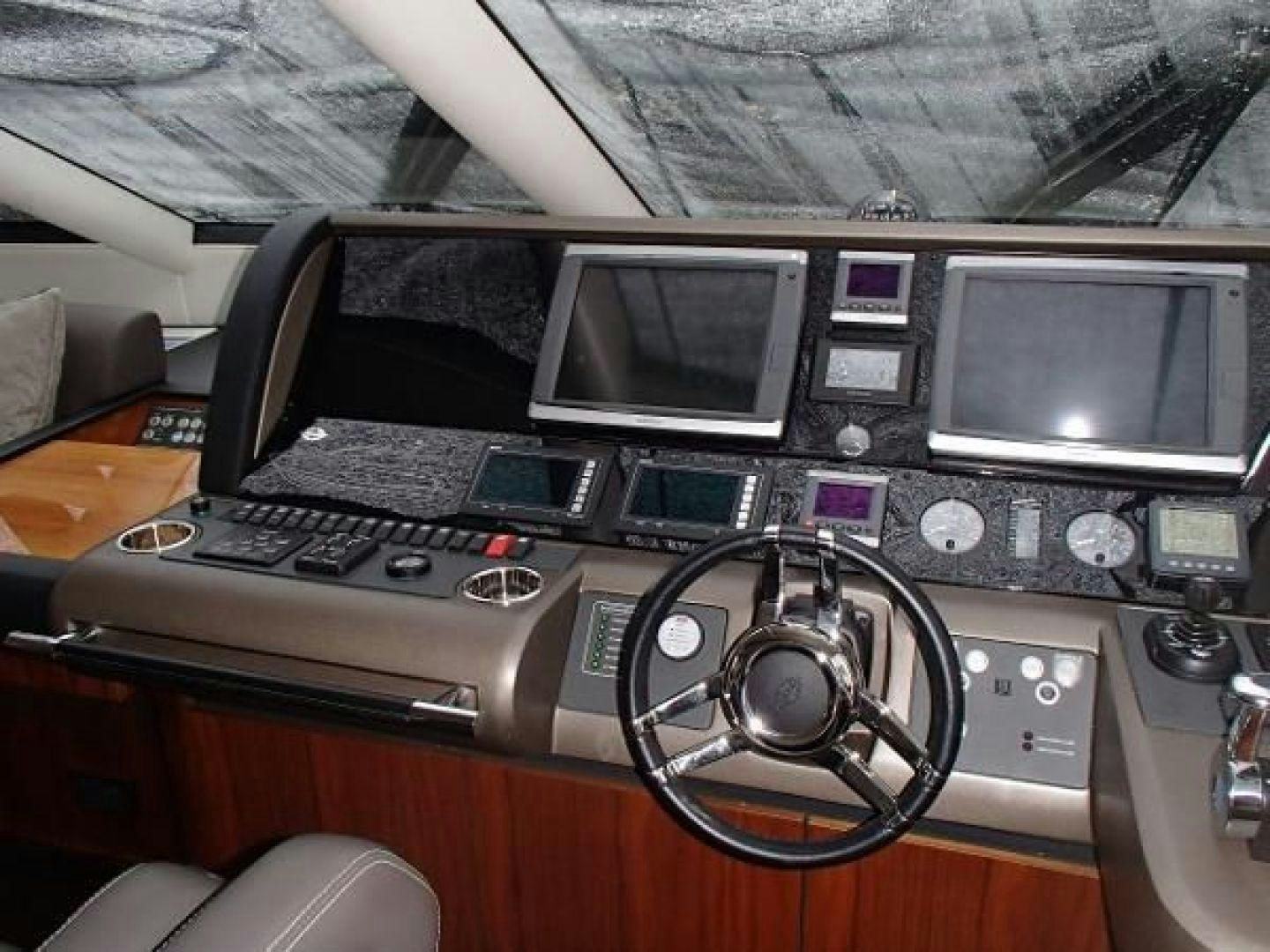 a car stereo and a laptop on a table aboard GEMINI Yacht for Sale