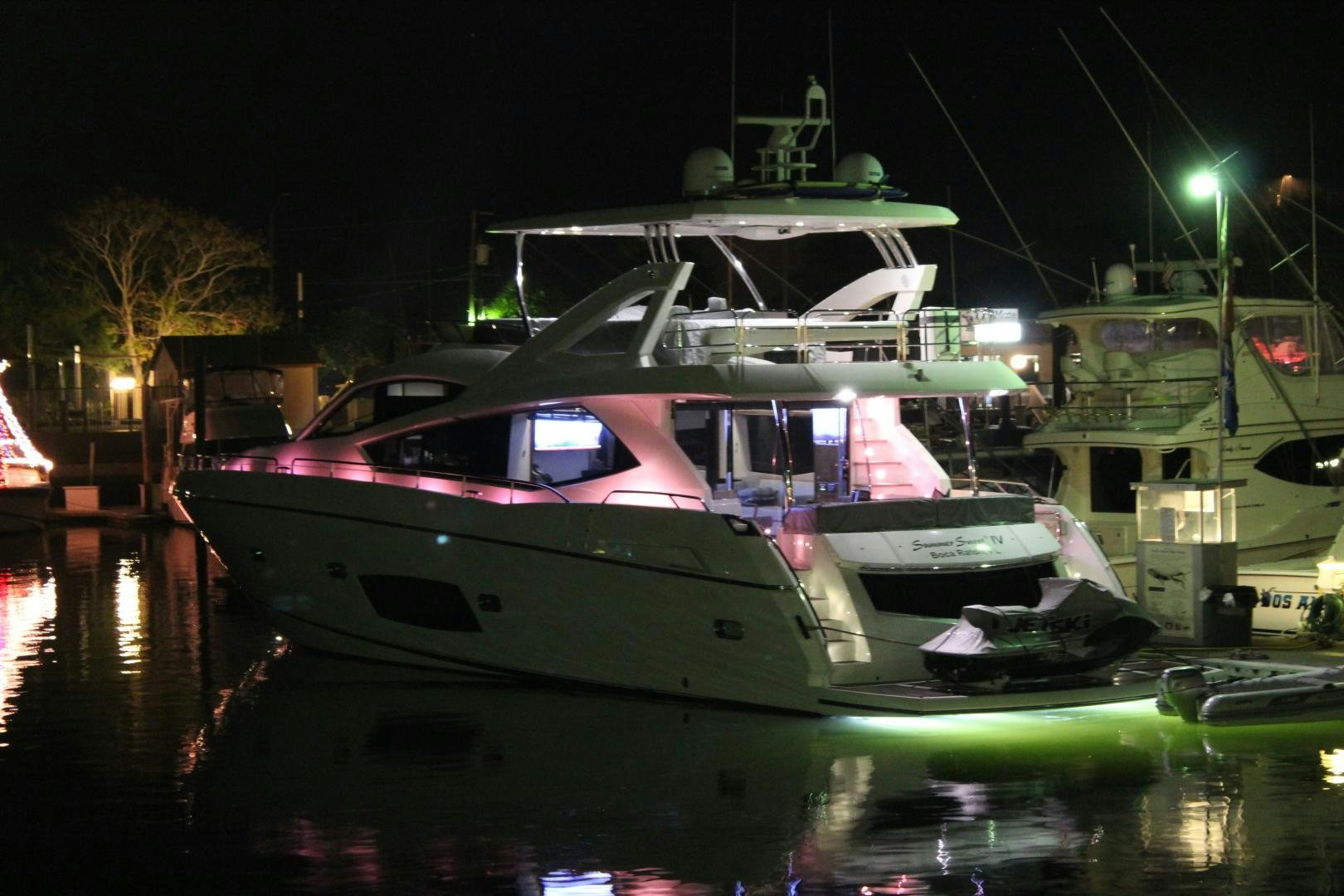 a boat docked at night aboard GEMINI Yacht for Sale
