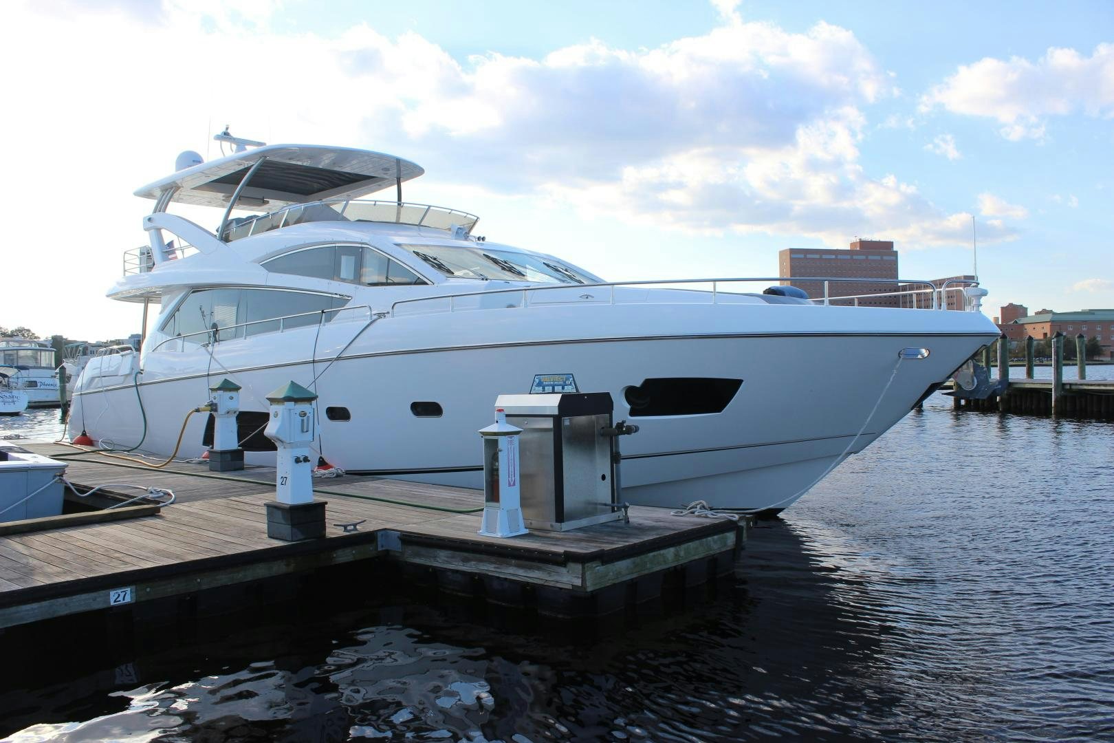 a white yacht docked at a dock aboard GEMINI Yacht for Sale