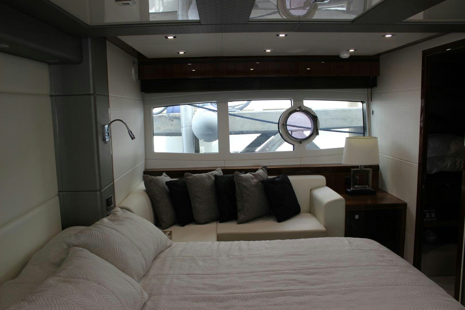 a bed with a white bed spread aboard GEMINI Yacht for Sale