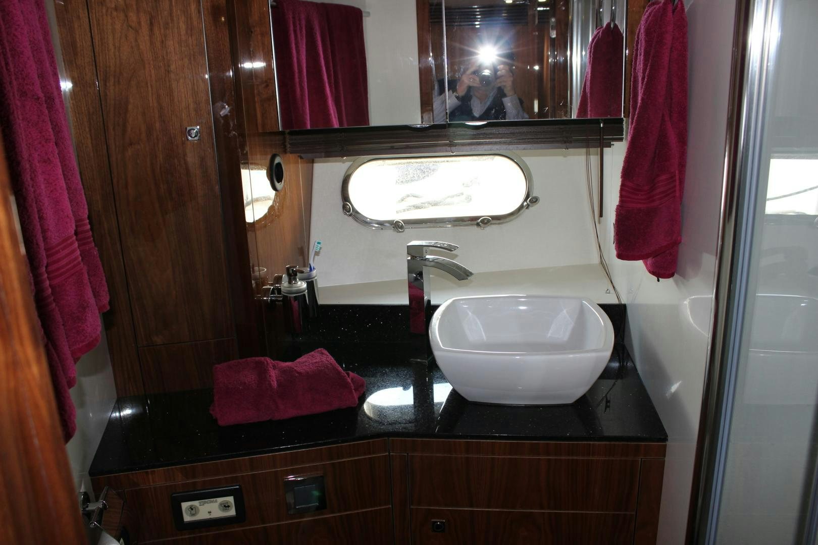 a bathroom with a sink and mirror aboard GEMINI Yacht for Sale