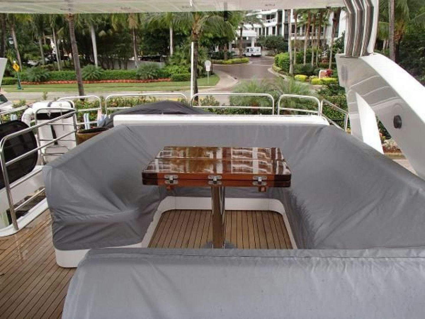 a table outside with chairs around it aboard GEMINI Yacht for Sale