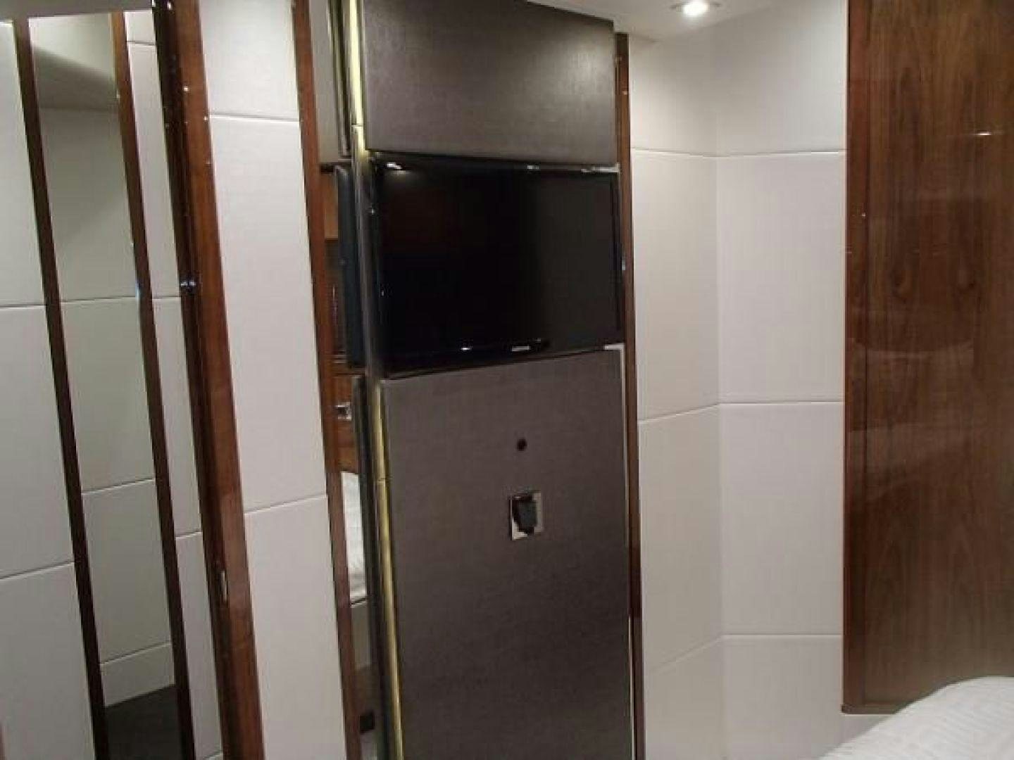 a black microwave on a black microwave oven on a white tile wall aboard GEMINI Yacht for Sale