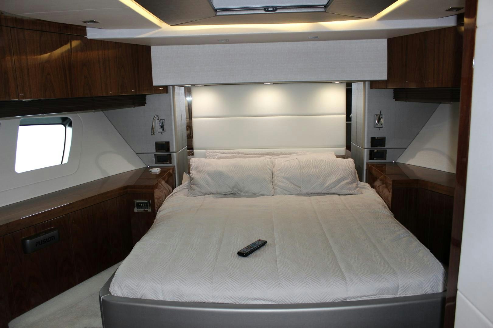 a bed with a phone on the end aboard GEMINI Yacht for Sale