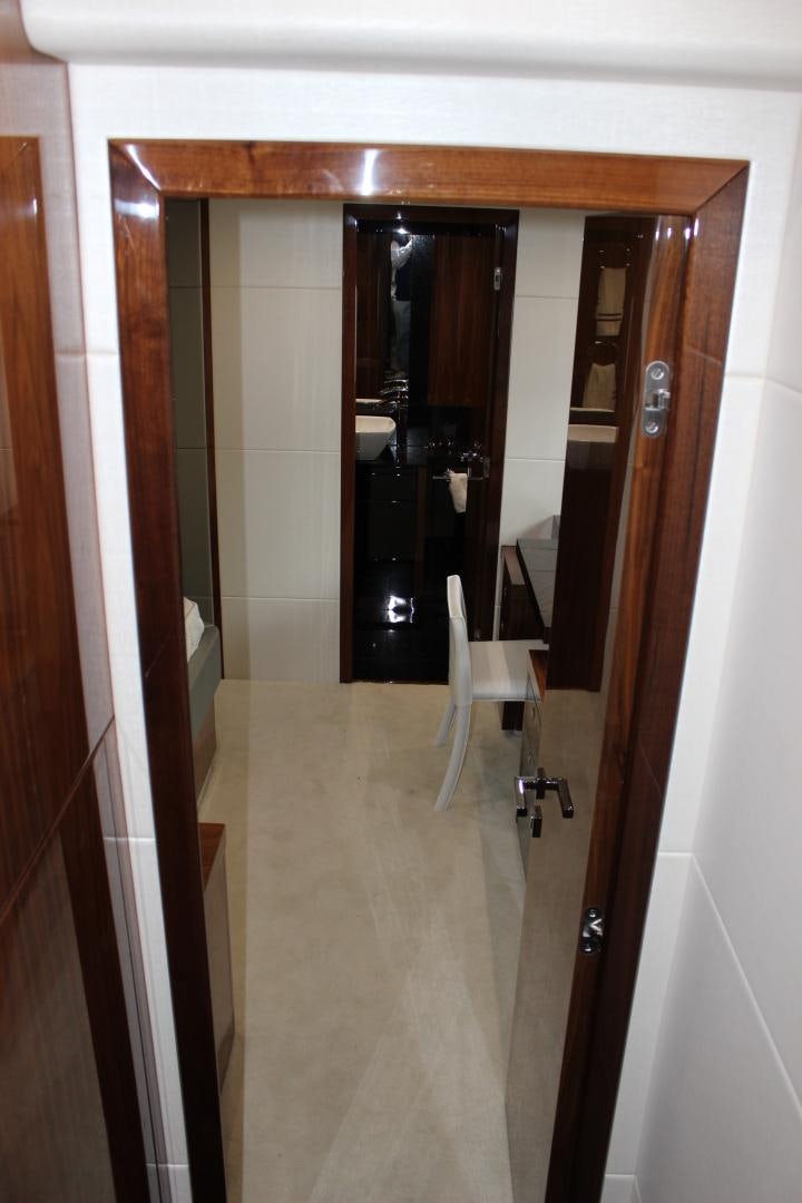 a room with a chair and a closet aboard GEMINI Yacht for Sale