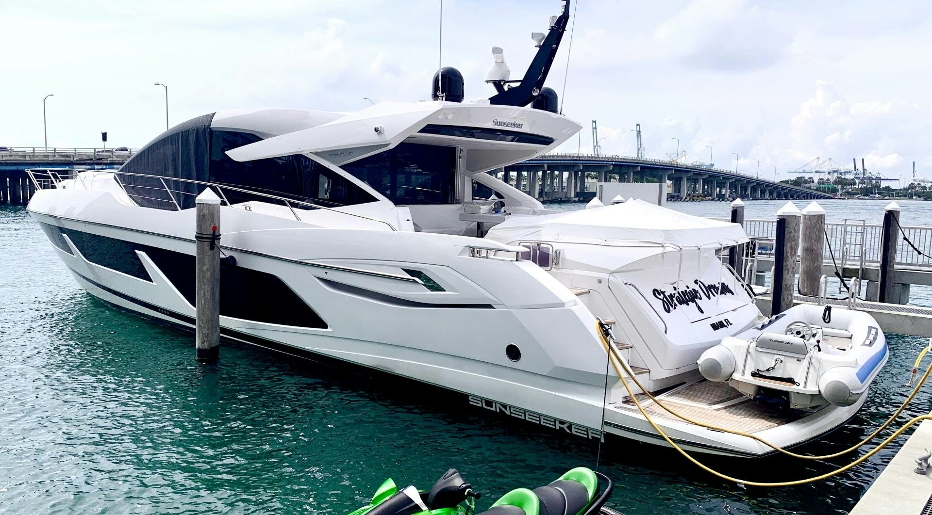 a white yacht docked at a dock aboard STRATEGIC DREAMS Yacht for Sale
