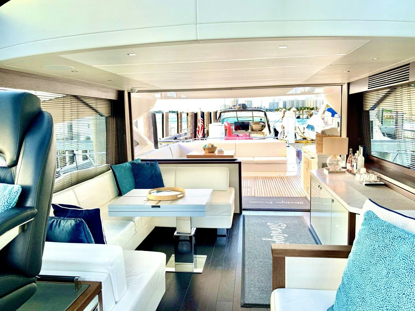 a room with a car and a table and chairs aboard STRATEGIC DREAMS Yacht for Sale