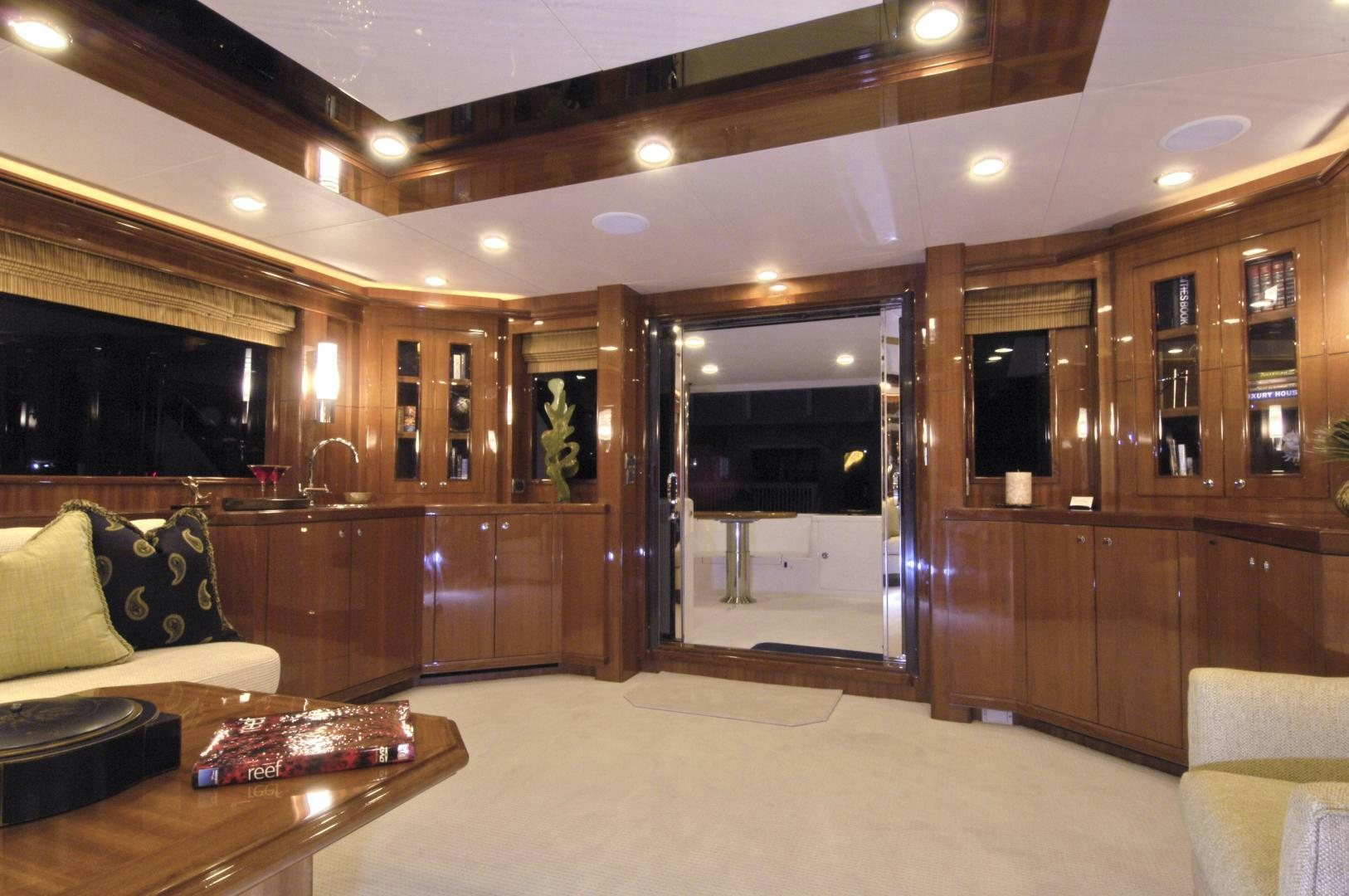 a large living room with wood cabinets aboard HATT TRICK Yacht for Sale