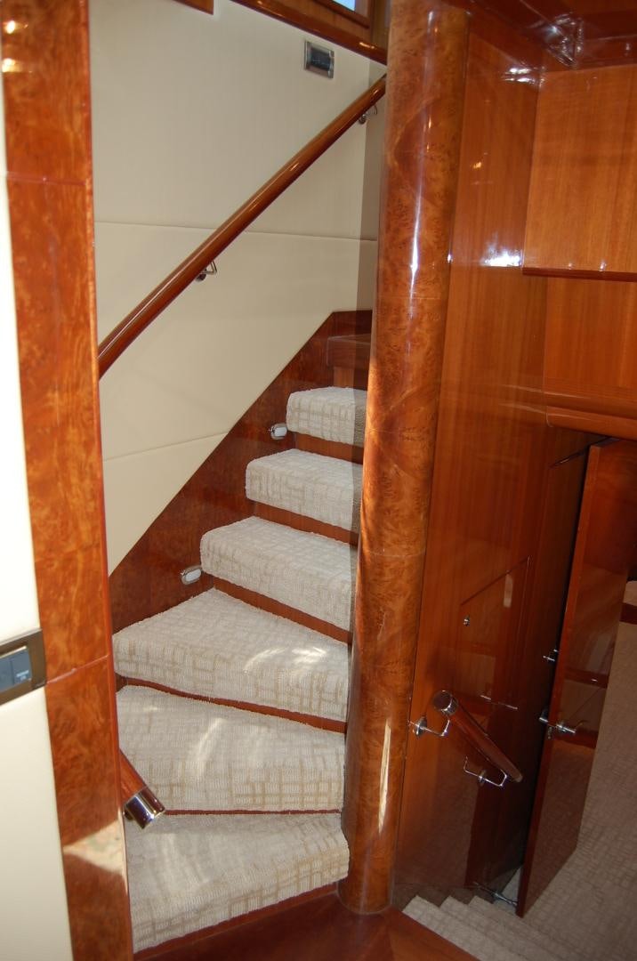 a wooden staircase with a wood railing aboard HATT TRICK Yacht for Sale