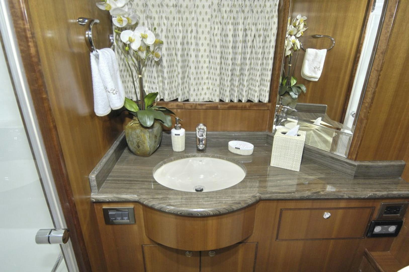 a bathroom with a sink and a mirror aboard HATT TRICK Yacht for Sale