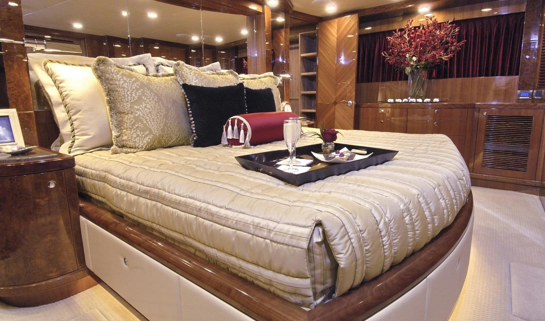 a bed with a white sheet and pillows on it aboard HATT TRICK Yacht for Sale
