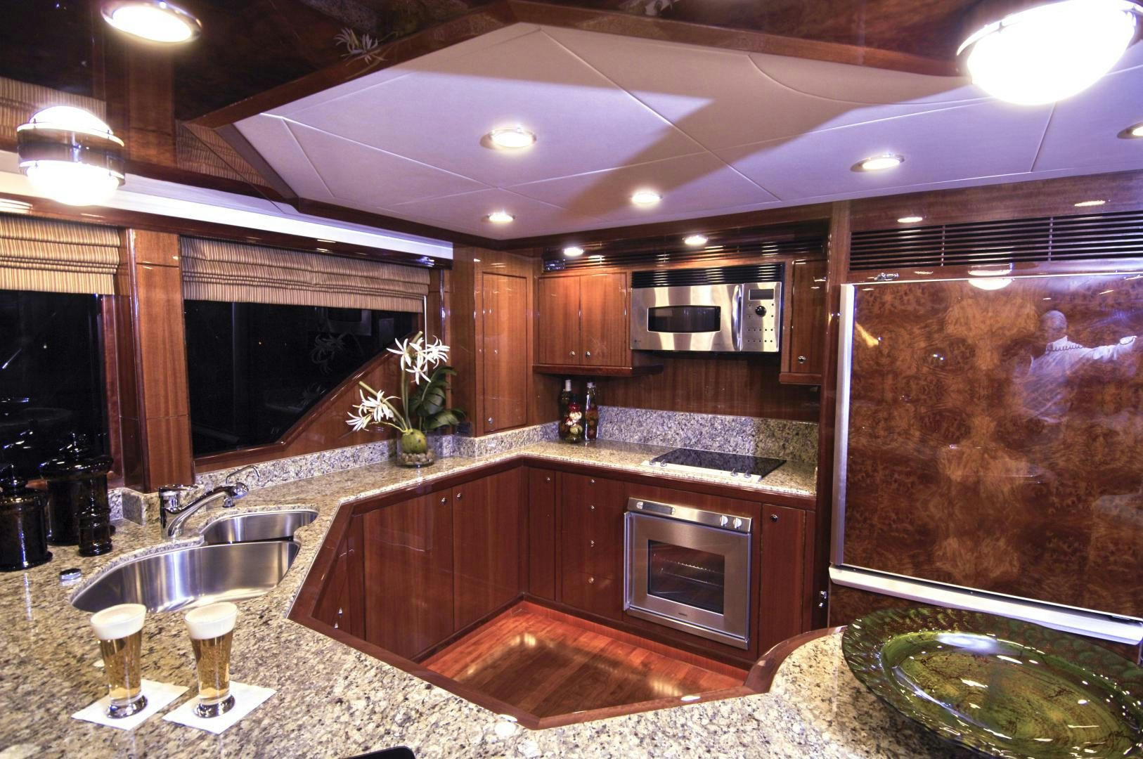 a kitchen with wooden cabinets aboard HATT TRICK Yacht for Sale