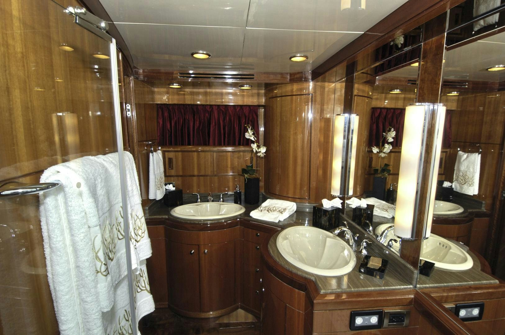 a bathroom with two sinks and a large mirror aboard HATT TRICK Yacht for Sale
