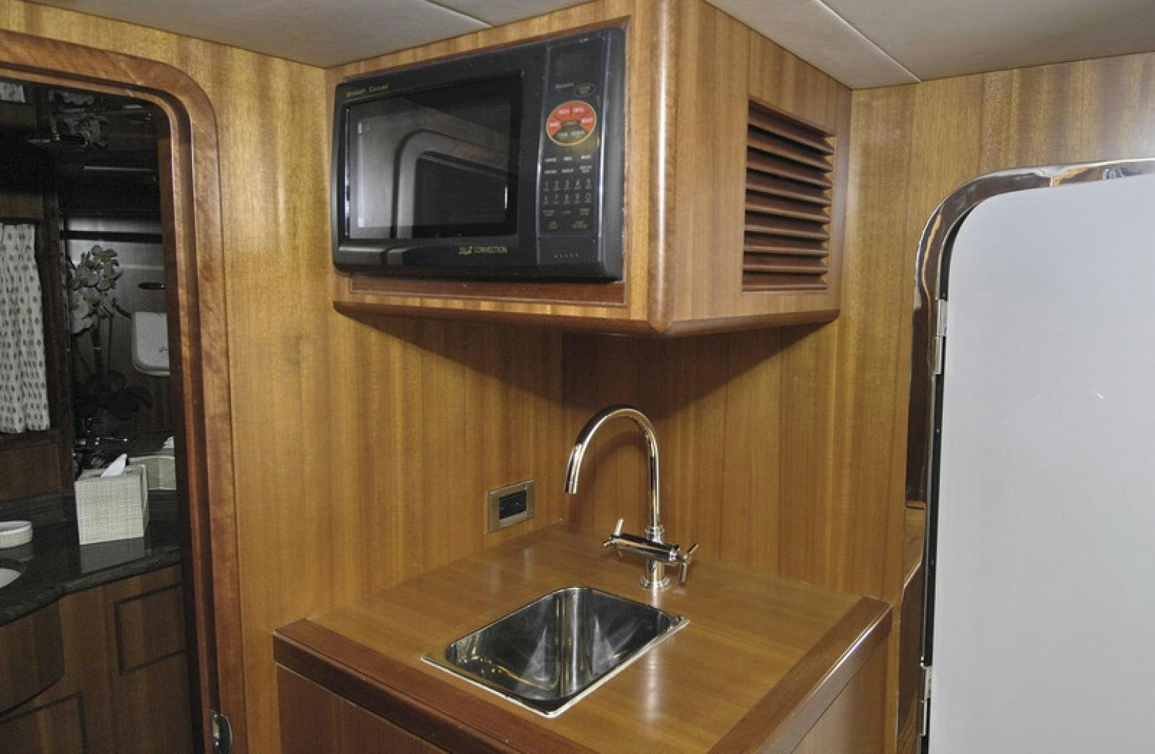 a kitchen with a microwave oven aboard HATT TRICK Yacht for Sale