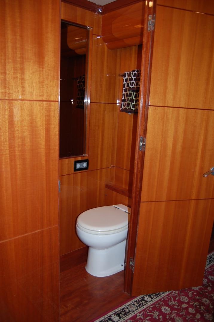 a toilet in a wooden room aboard HATT TRICK Yacht for Sale
