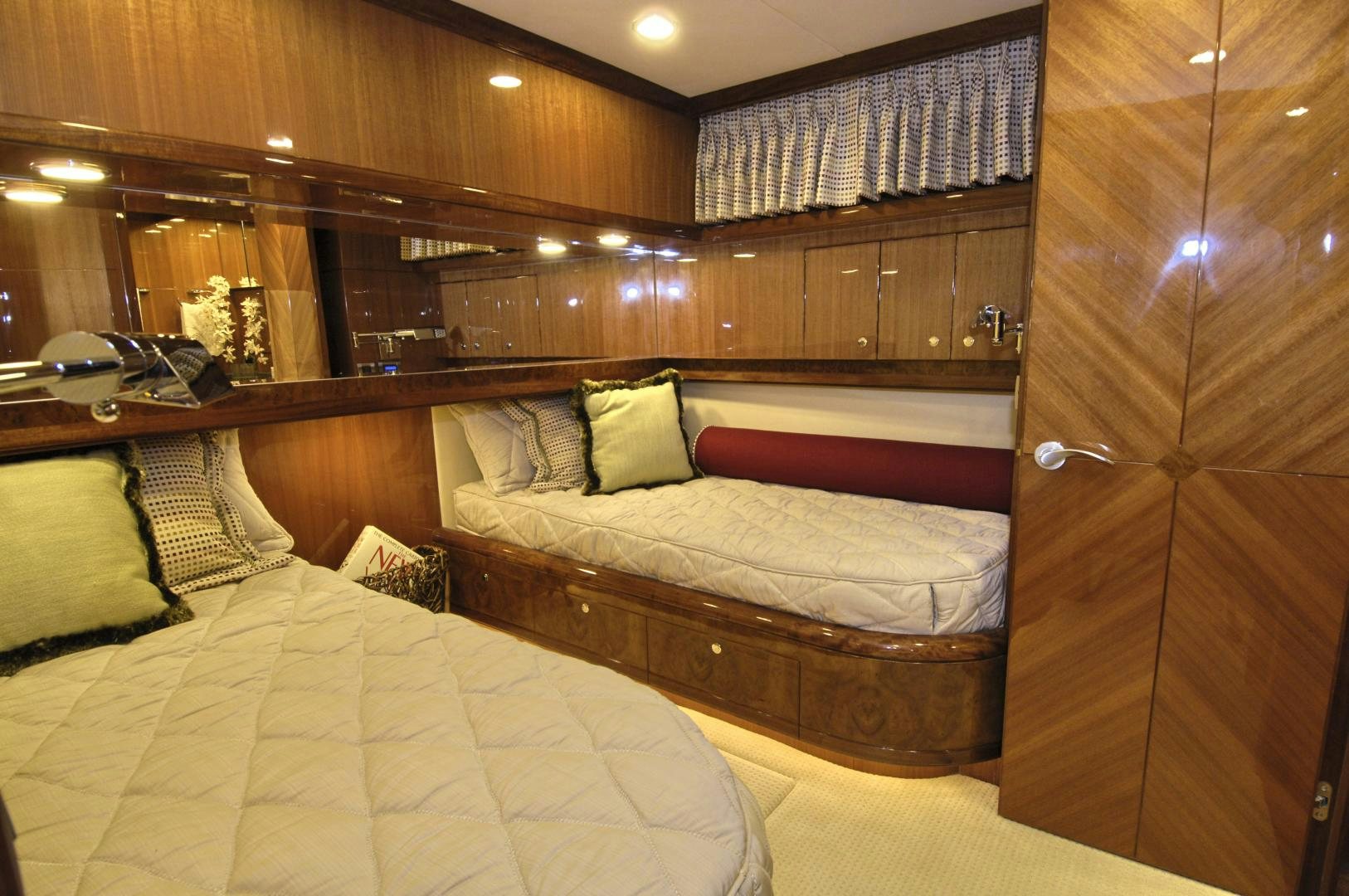 a room with a bed and a wood wall aboard HATT TRICK Yacht for Sale