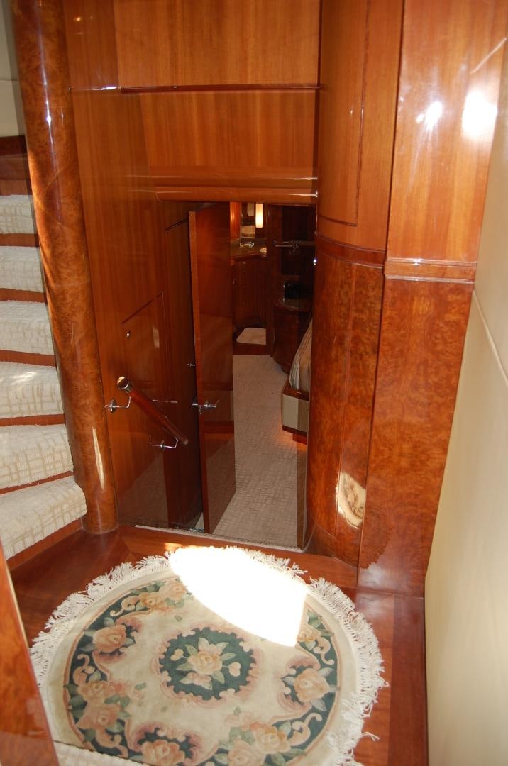 a room with a wood door and a rug on the floor aboard HATT TRICK Yacht for Sale