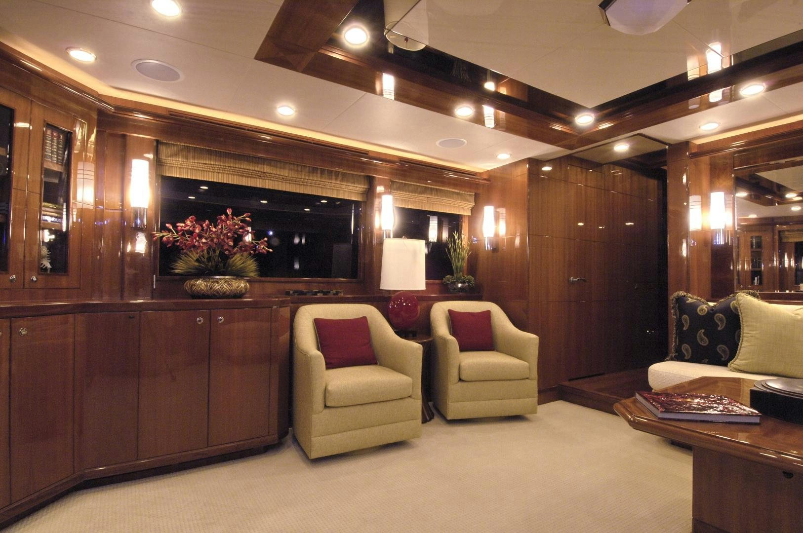 a room with a couch and a table and a chair aboard HATT TRICK Yacht for Sale