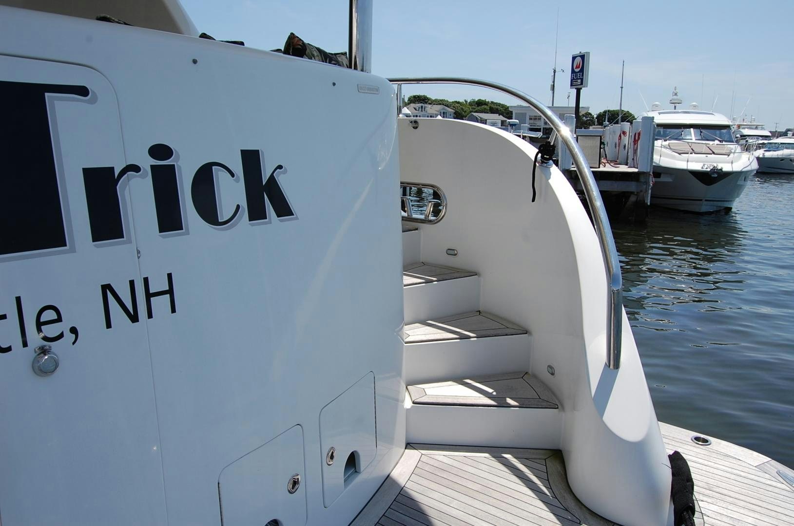 a white boat with black text on it aboard HATT TRICK Yacht for Sale