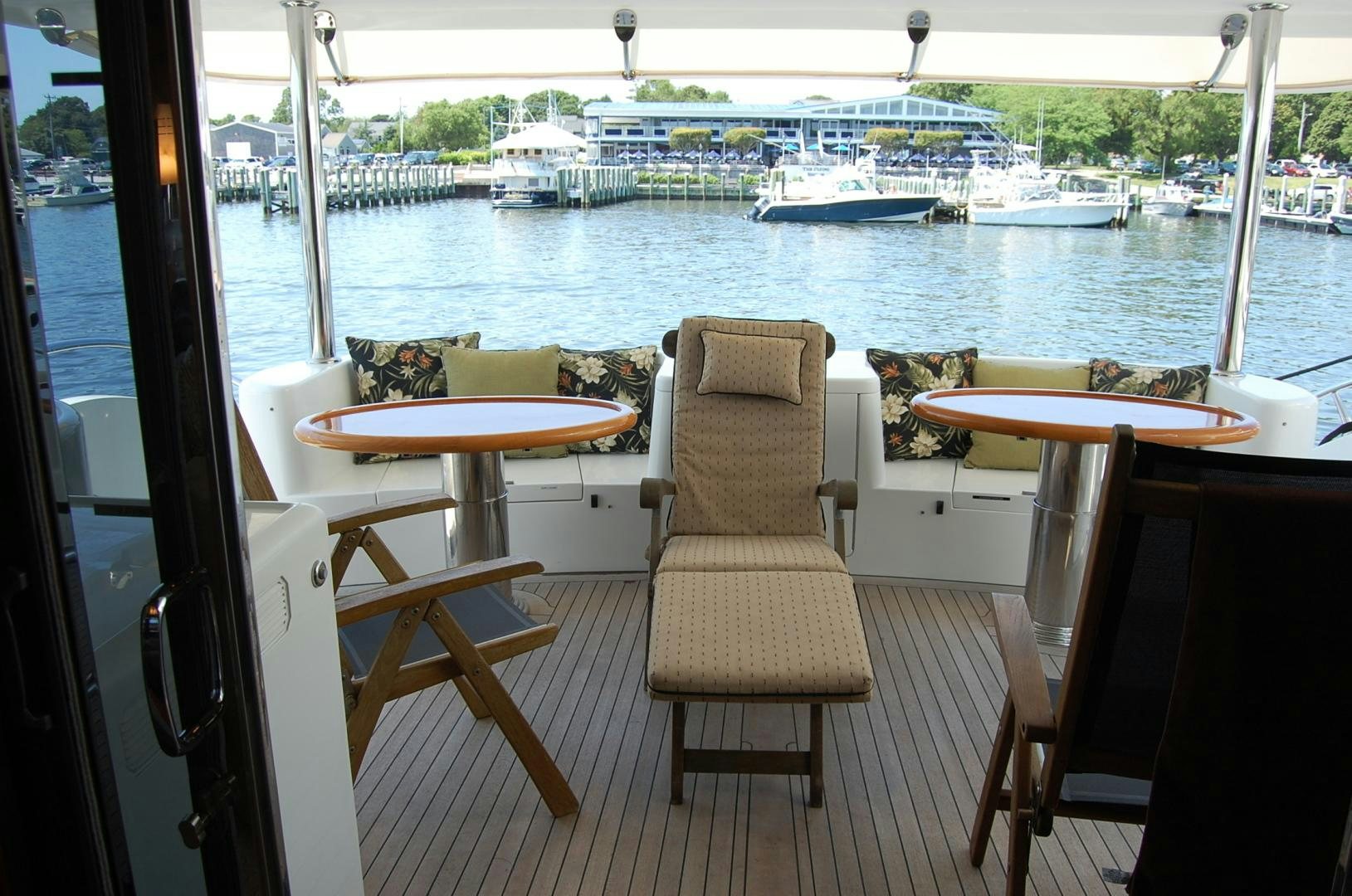 a room with a table chairs and a view of the water aboard HATT TRICK Yacht for Sale