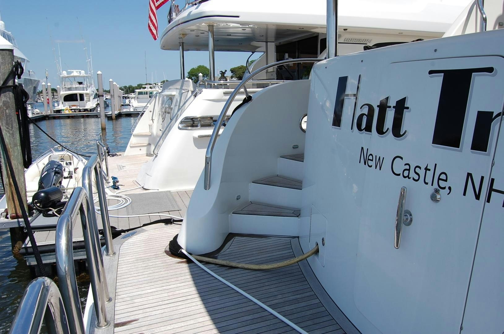 a boat with a sign on the front aboard HATT TRICK Yacht for Sale