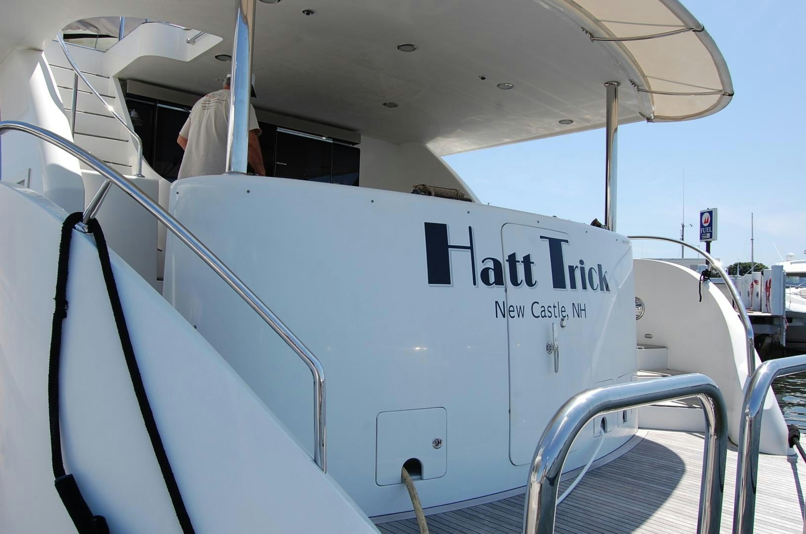 a boat with a sign on the side aboard HATT TRICK Yacht for Sale