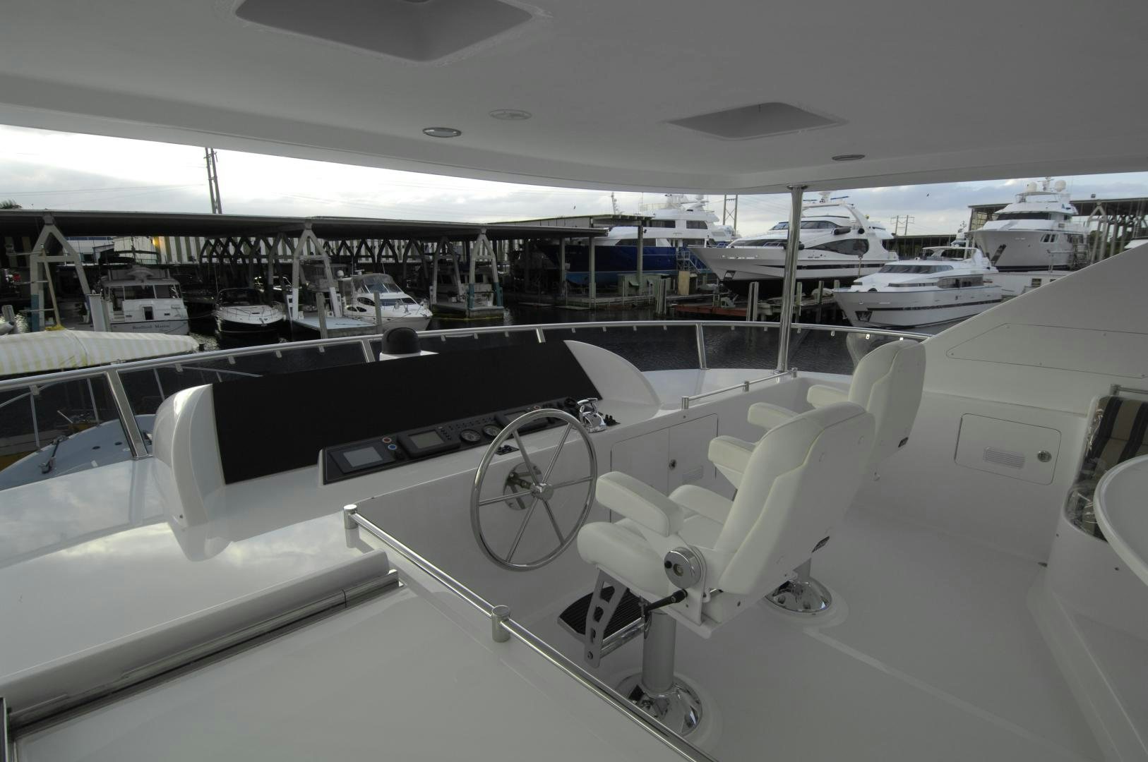 a room with many white chairs aboard HATT TRICK Yacht for Sale