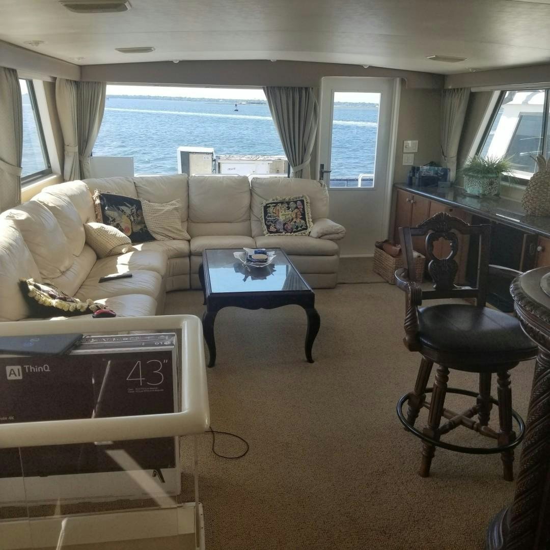 a living room with a couch and a table aboard CAROLINA WIND Yacht for Sale