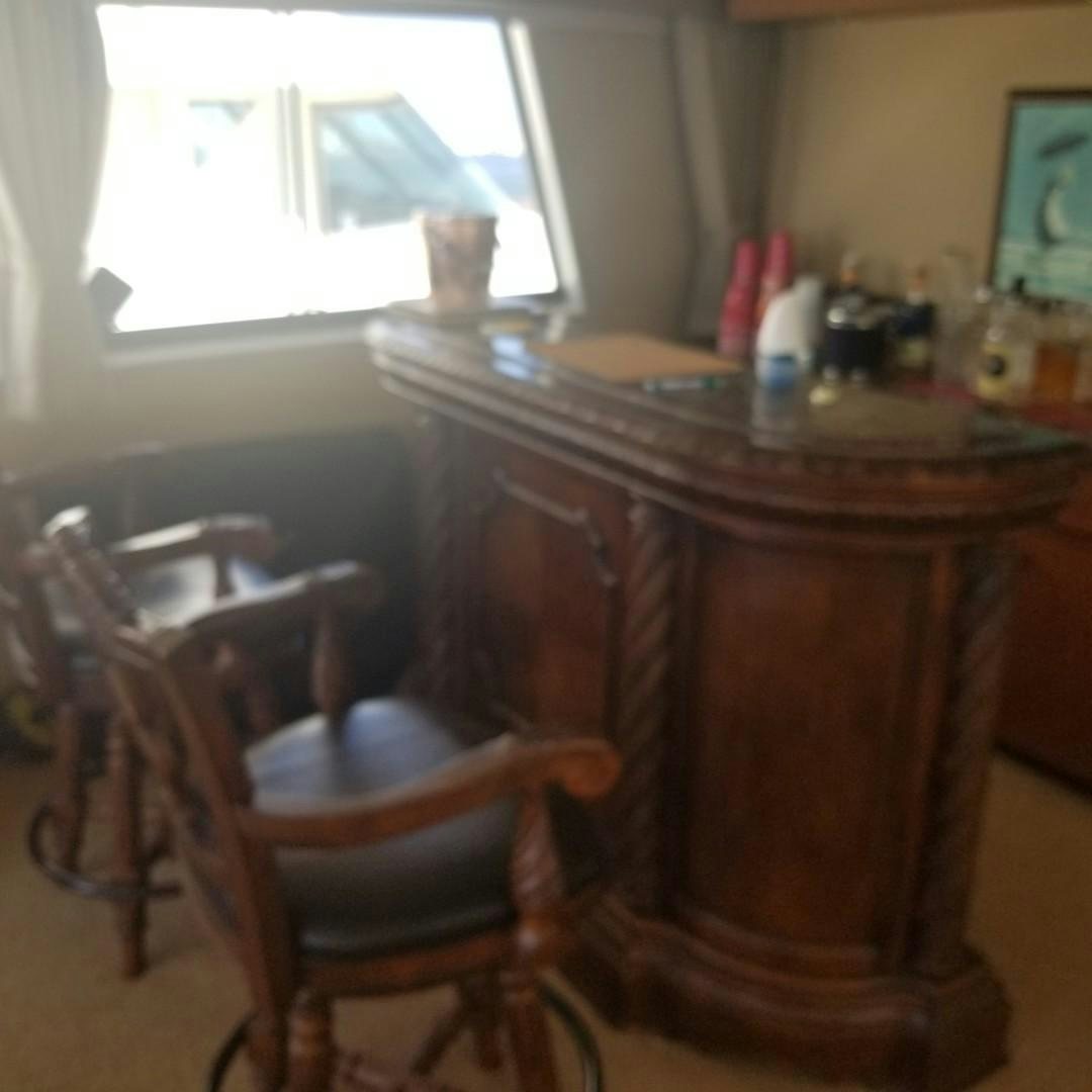 a wooden table with a chair and a window aboard CAROLINA WIND Yacht for Sale
