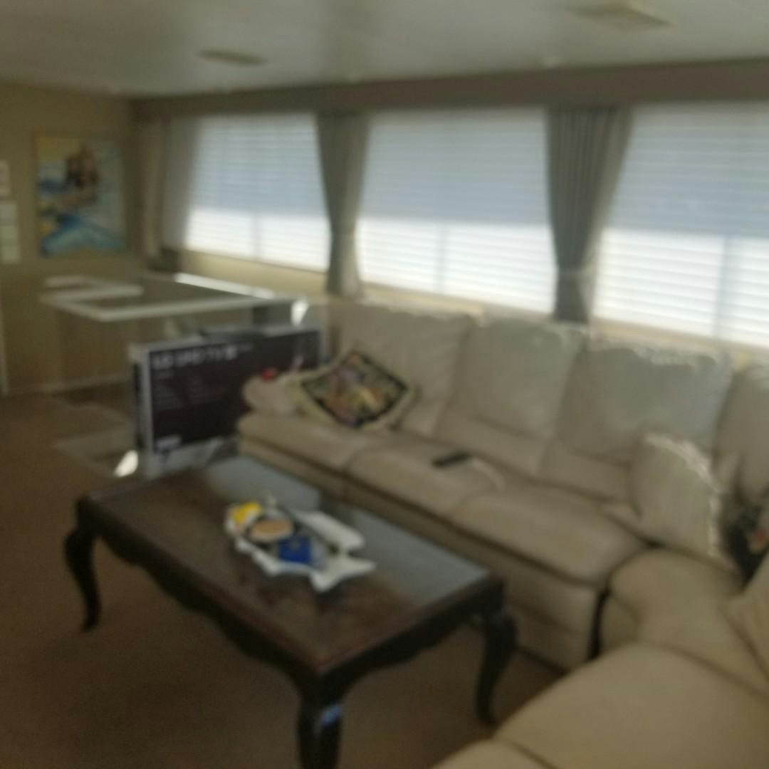 a living room with a couch and a table aboard CAROLINA WIND Yacht for Sale