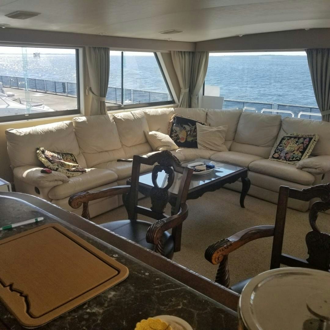 a living room with a couch and a table aboard CAROLINA WIND Yacht for Sale