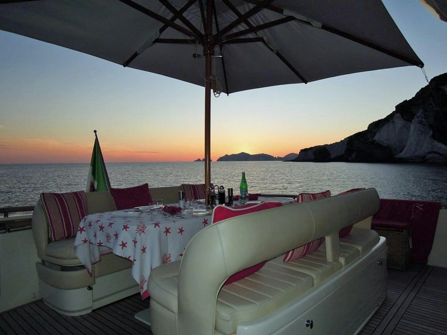 a table and chairs on a deck aboard No Name Yacht for Sale