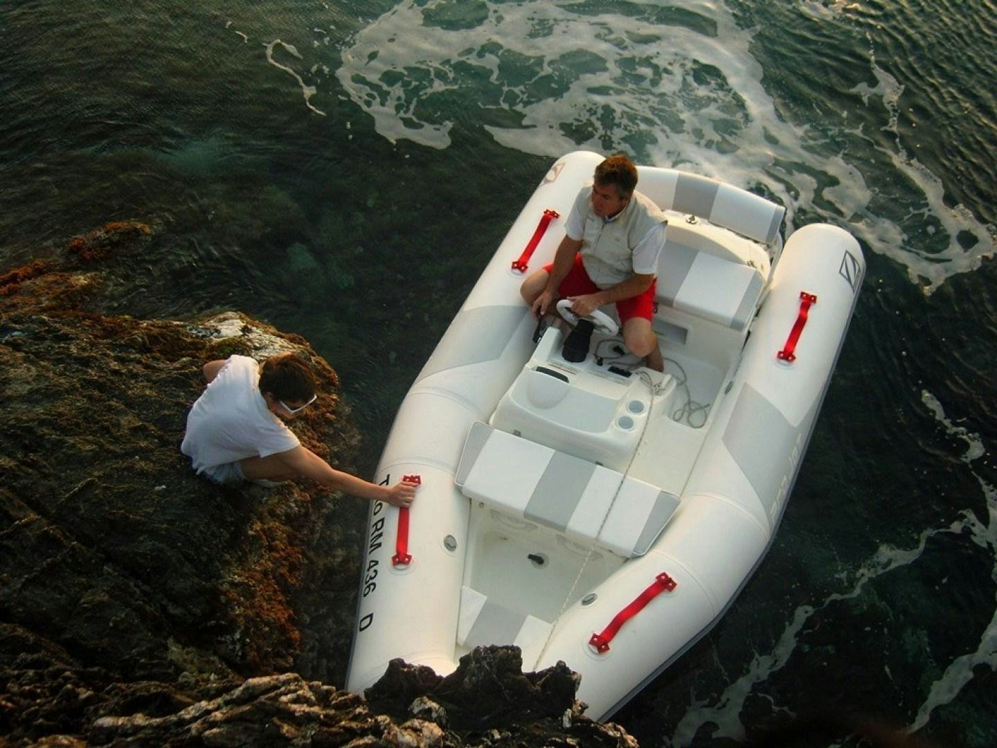 a man and woman in a boat aboard No Name Yacht for Sale