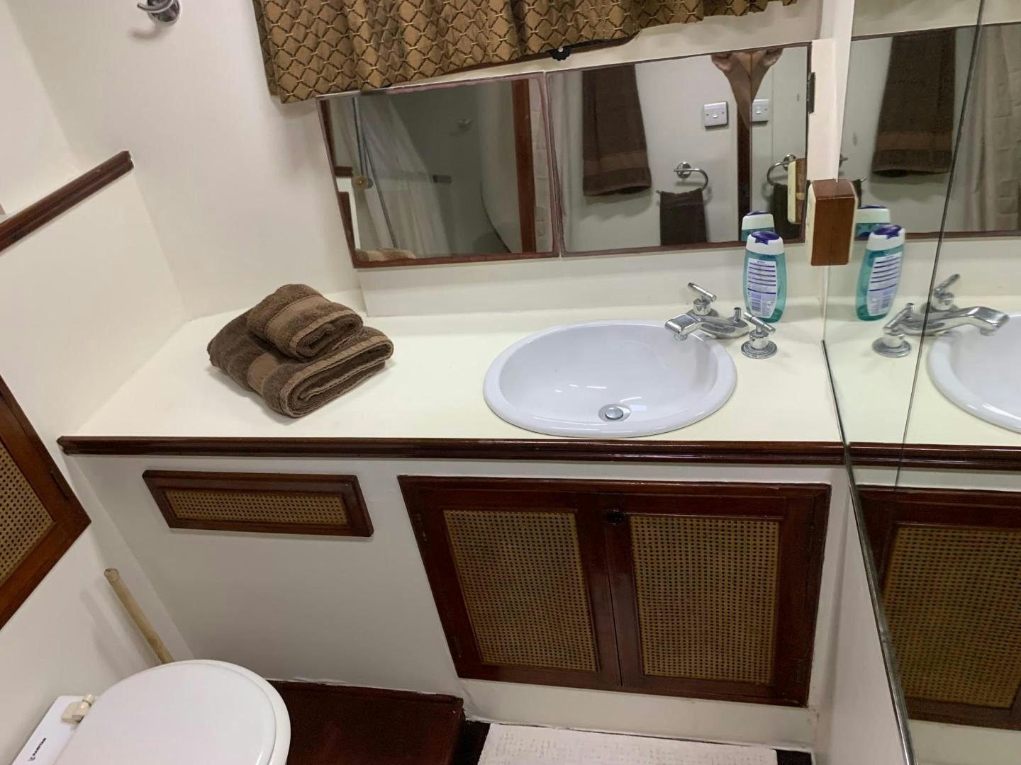 a bathroom with a sink and mirror aboard No Name Yacht for Sale
