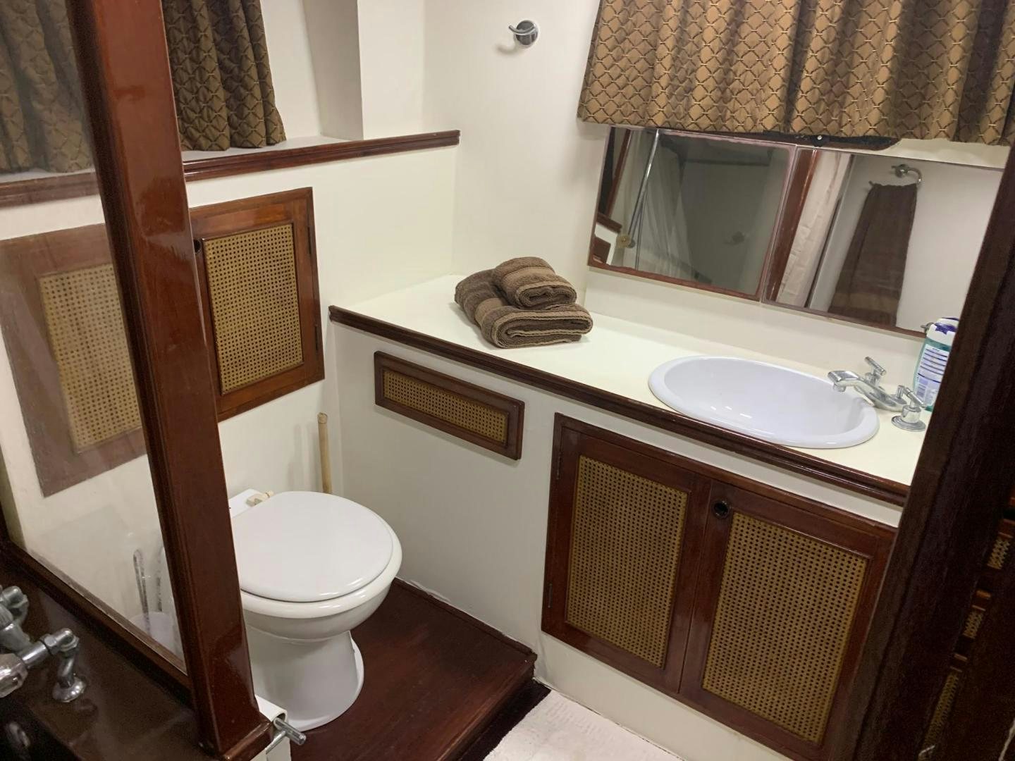 a bathroom with a toilet sink and a mirror aboard No Name Yacht for Sale