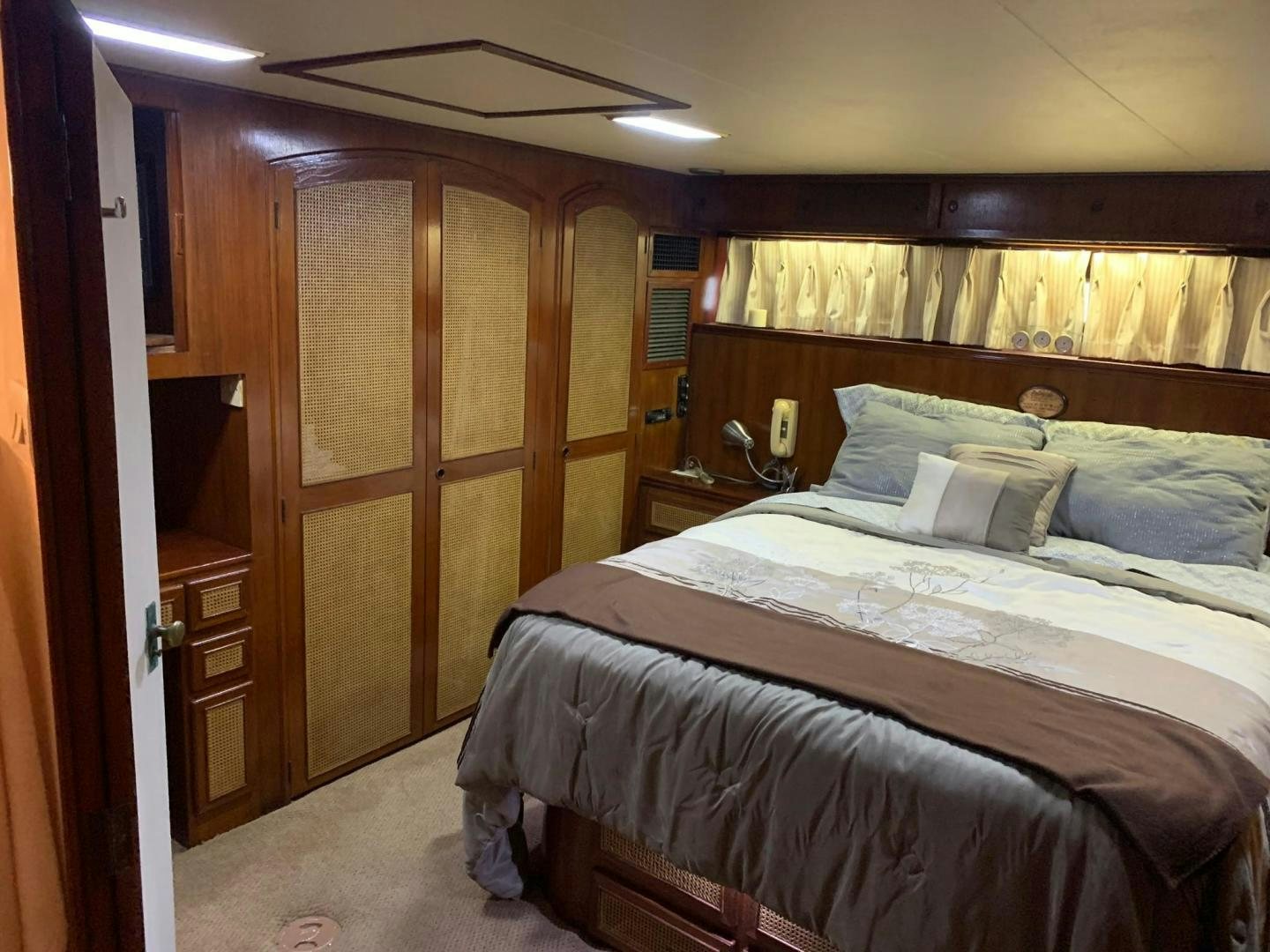 a bedroom with a bed and a closet aboard No Name Yacht for Sale