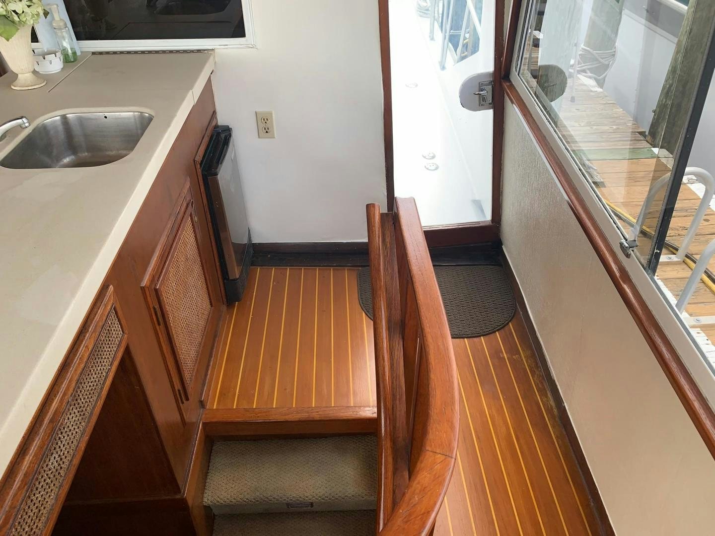 a wooden staircase in a kitchen aboard No Name Yacht for Sale