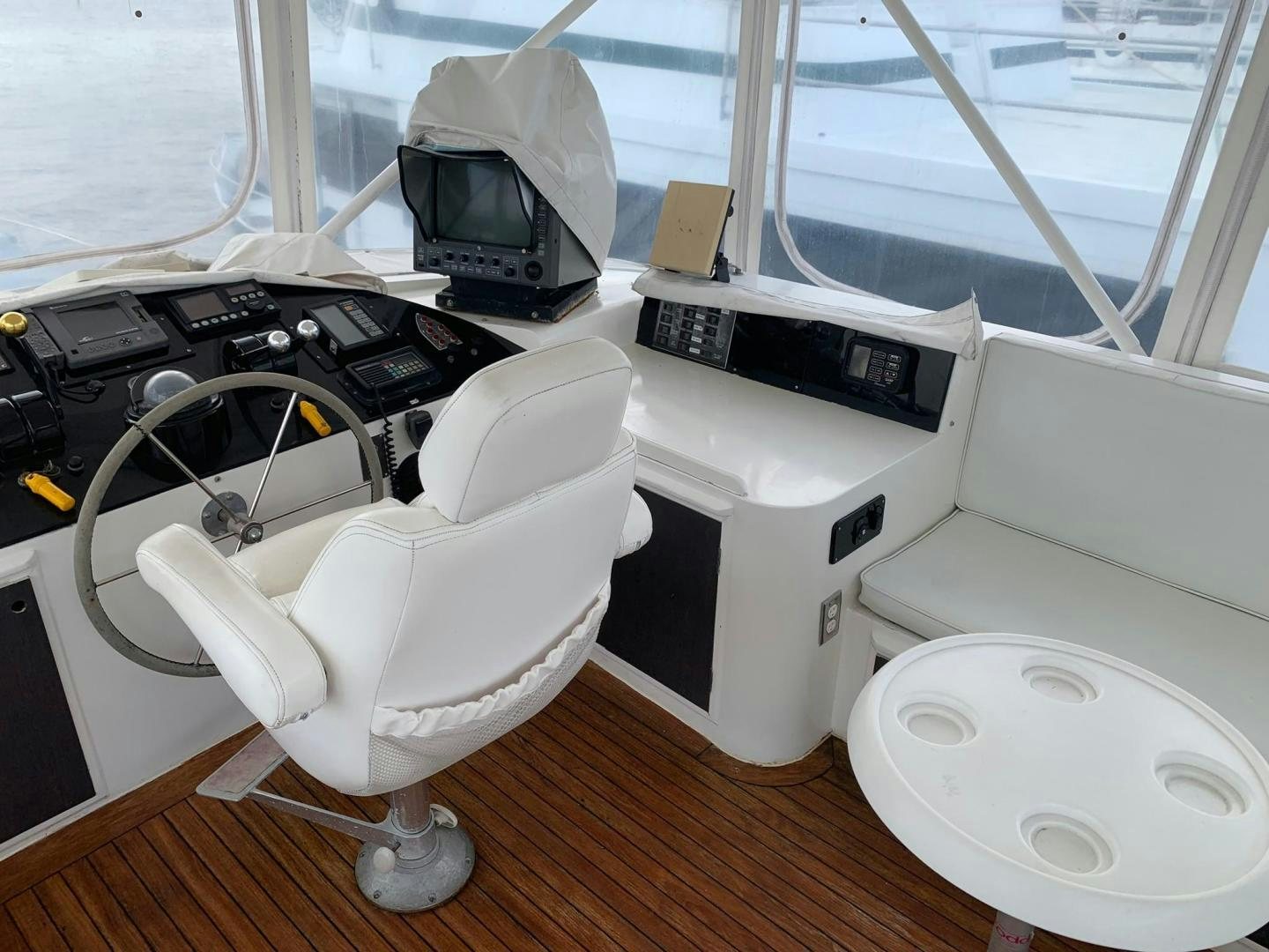 a room with a large window and a desk with a computer and other objects aboard No Name Yacht for Sale