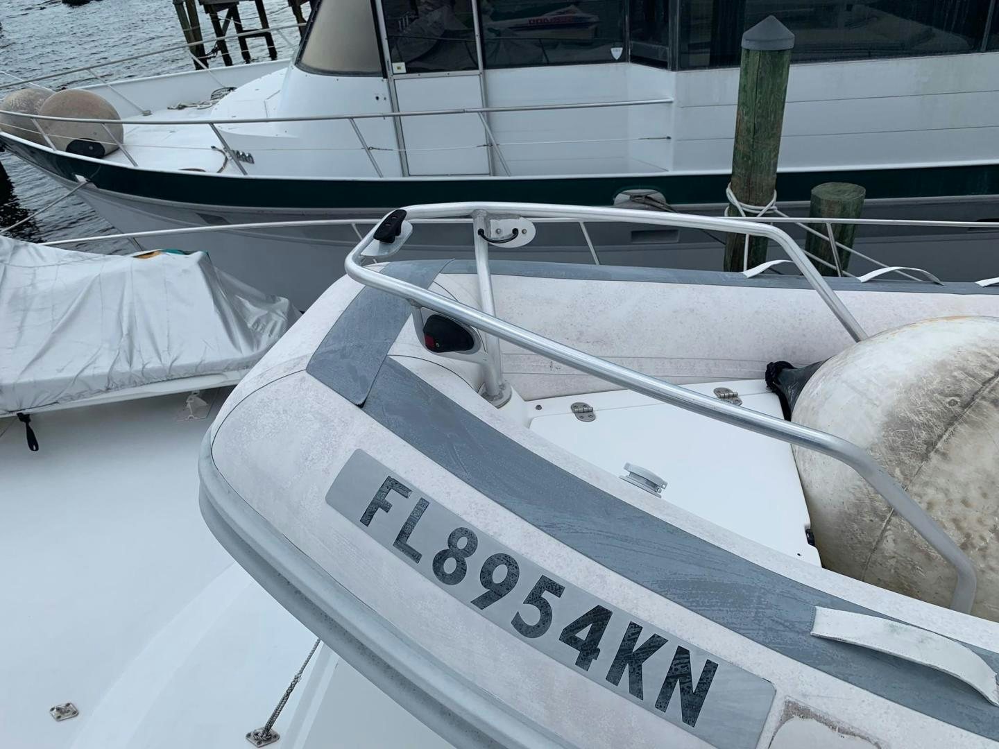 a white boat with a sign on it aboard No Name Yacht for Sale
