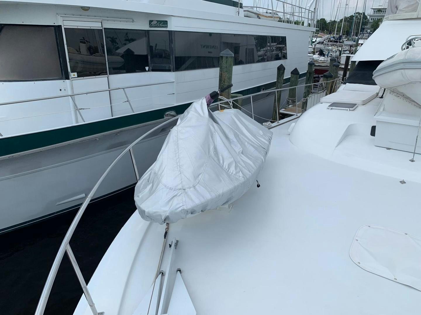 a white boat with a white sheet on it aboard No Name Yacht for Sale