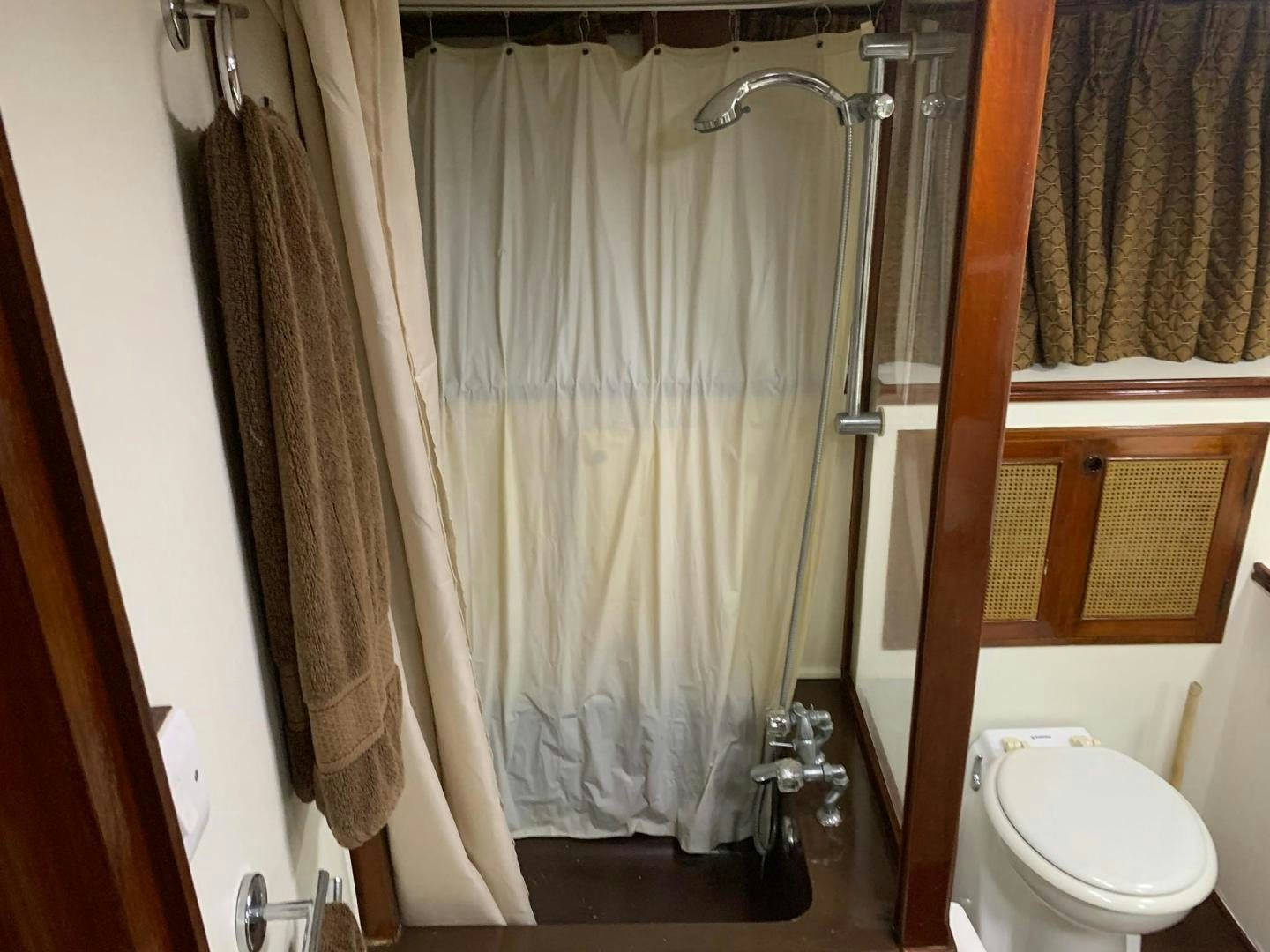 a bathroom with a shower curtain aboard No Name Yacht for Sale