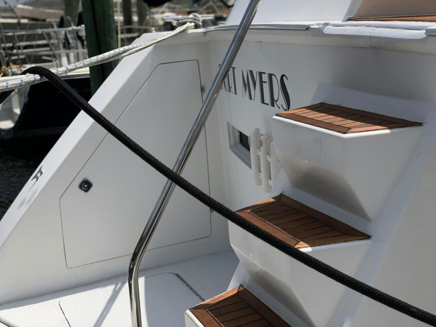a white boat with a wooden frame aboard No Name Yacht for Sale