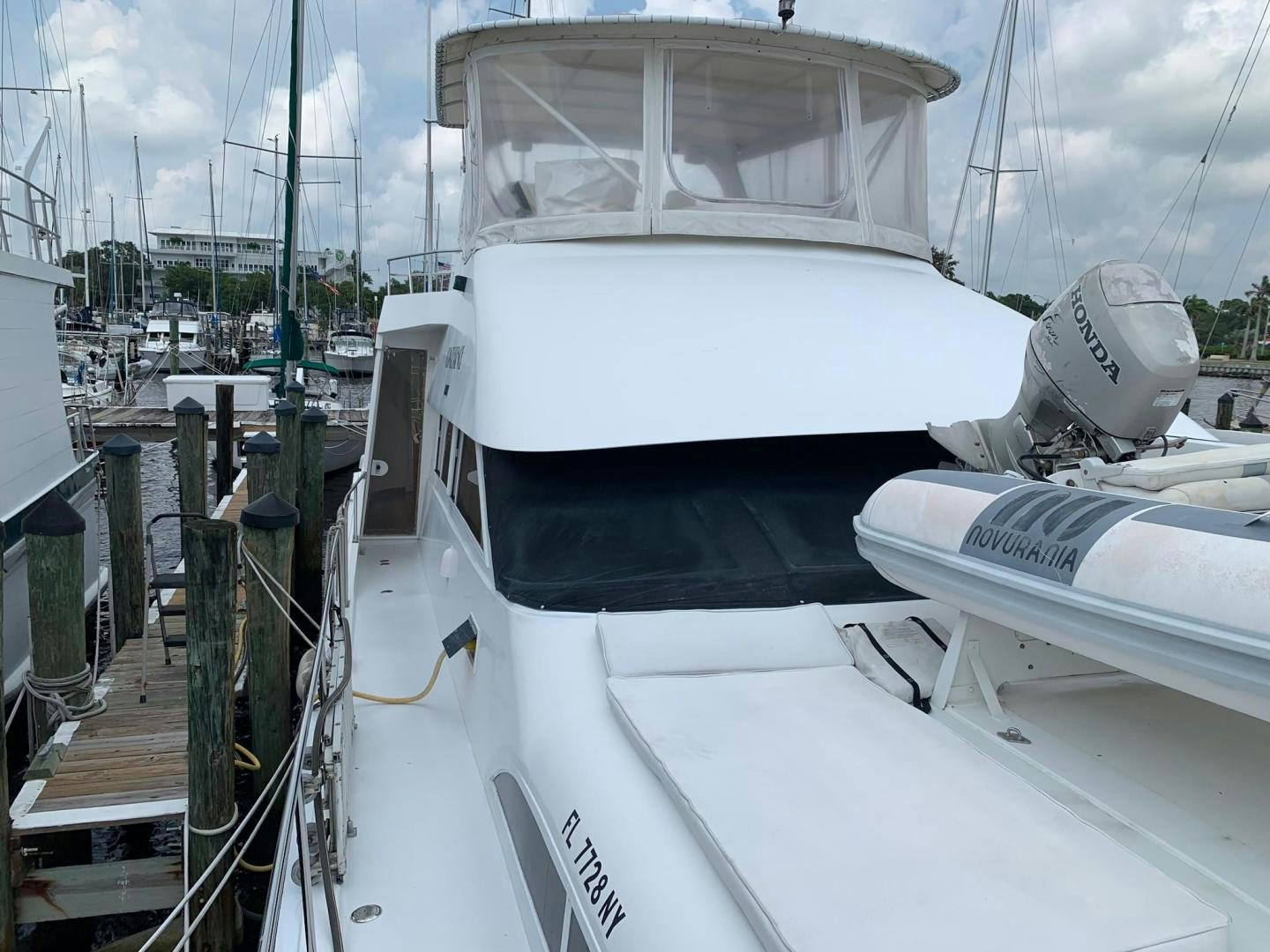 a white boat on a deck aboard No Name Yacht for Sale
