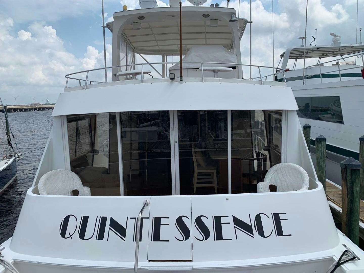 a white boat with a sign on it aboard No Name Yacht for Sale